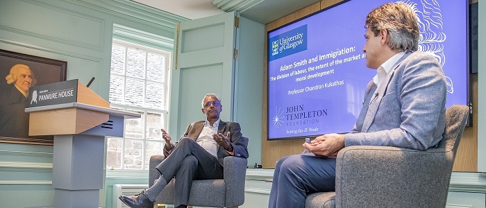 Professor Chandran Kukathas speaking at a lecture saying Panumure house with a presentation behind him Source: Charlotte