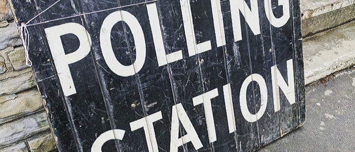 Wooden sign with the text in all capitals