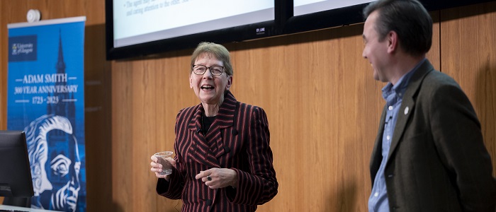 Christel Fricke standing with Craig Smith presenting at the Hunter Foundation Lecture. Source: Charlotte Morris
