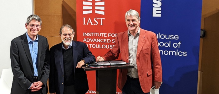 three of the speakers from the Toulouse smith around the world event smiling around a podium Source: Amy Laux