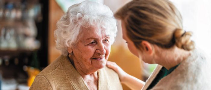 A woman comforts an elderly woman