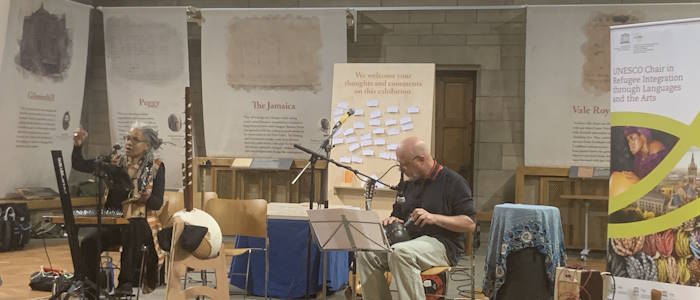 Edugie Clare Robertson and Dominic Snyder playing musical instruments on stage