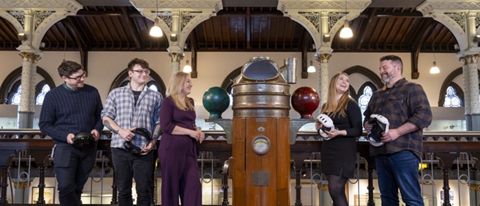 Museums in the Metaverse 3: (l - r) The University of Glasgow ’ s Professor Neil McDonnell, principal investigator of the Museums in the Metaverse project, and Dr Pauline Mackay, who led the development of the L ord Kelvin exhibition, pose with VR headsets beside a bust of Lord Kelvin in The Hunterian. Credit Martin Shields