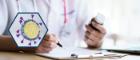 Healthcare professional writing notes while holding medication bottle, with coronavirus illustration overlay