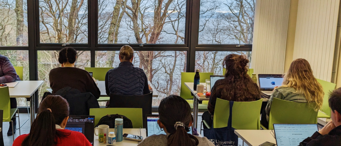 SCAF colleagues writing inside with a view of Loch Lomond