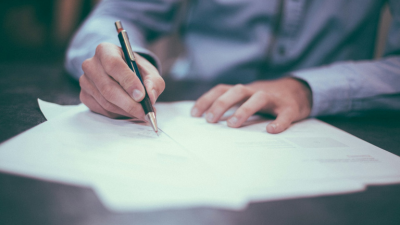 A photo of a person taking notes on paper