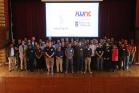 Attendees of nanoFabUK 2025 standing on the stage at the Glasgow University Union Debates Chamber