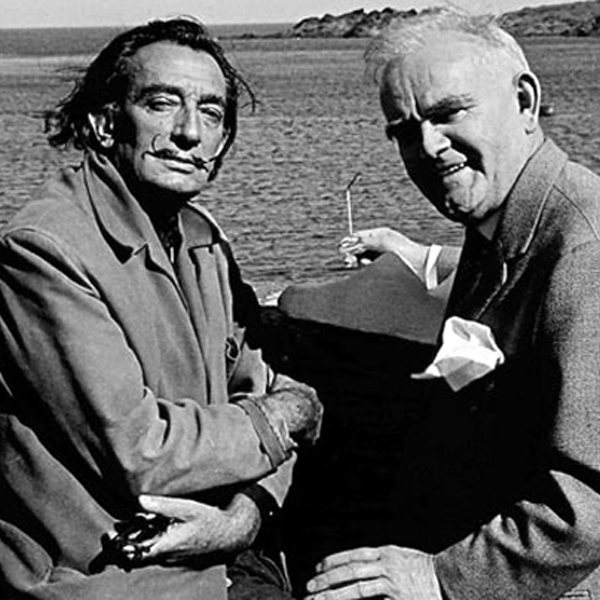 Dali looking at the camera next to a friend