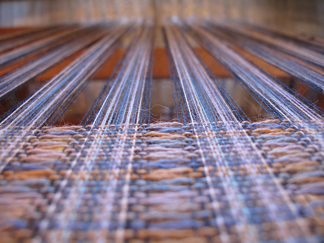 Close up of wool on a large weaving loom