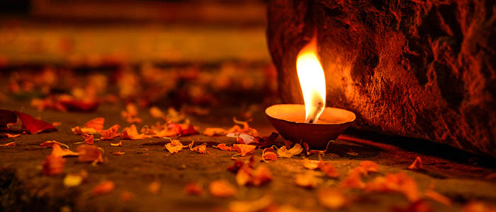 Candle surrounded by petals