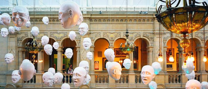 Sculpture of heads hang in Kelvingrove Gallery
