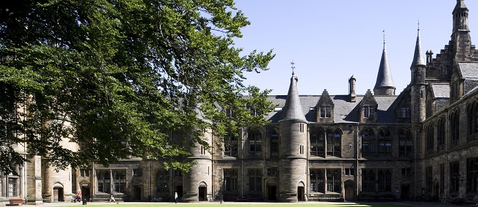 Sunny day with blue sky looking across the East Quad, students walking in background