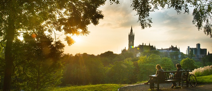 Sunset view across Kelvingrove Park to the tower framed by leaves