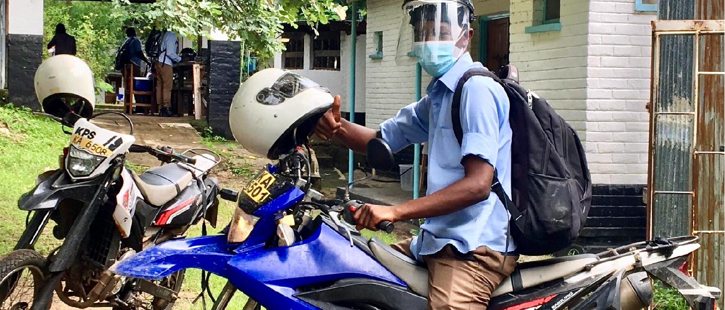 Man sitting on a motorbike in Malawi.
