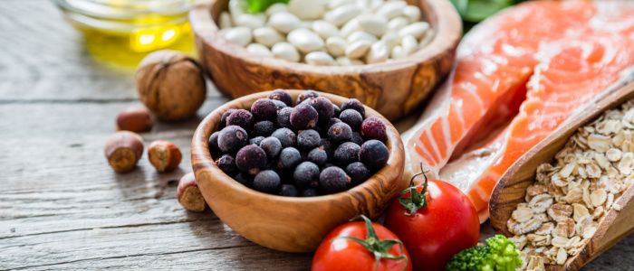 Close up of fruits, vegetables, nuts, fish and beans