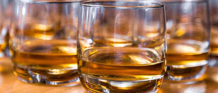 Glass tumblers holding whisky. Image credit: Vincent 20044 | iStockphoto  https://www.istockphoto.com/photo/glasses-are-filled-with-whiskey-on-the-table-gm947491240-258710122