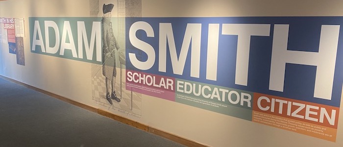 Panel at the entrance to an exhibition with the words 'Adam Smith. Scholar, Educator. Citizen.'
